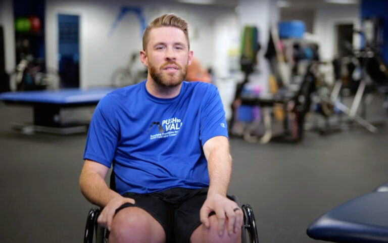 Co-founder and client Darren T. seated in his wheelchair in the Push to Walk gym